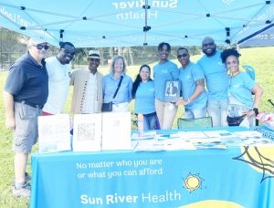 Employees from Sun River Health, the Title Sponsor of the Block Party, along with City of Beacon Mayor Lee Kyriacou on the far left, gather together during Saturday’s event.