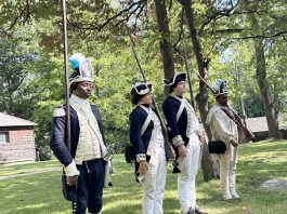 Members of the 1st Rhode Island Regiment perform military drills, including musket firings, for an attentive audience Saturday afternoon.