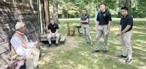 A member of the 1st Rhode Island Black Regiment discusses daily life with guests.